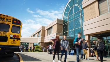 students walking in front of school