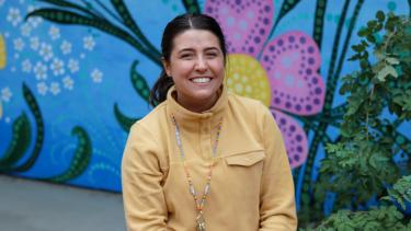 Madi Hendry - Teacher Young female teacher sits and smiles