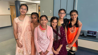 Howe Middle Students Celebrate Diwali Group of female middle school students in traditional attire celebrating Diwali