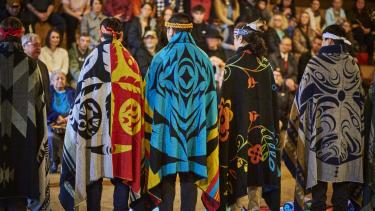 2023 Indigenous Role Model Honouring Five Indigenous Role Models blanketed and stand in the longhouse in front of their peers