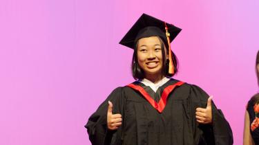 WJ Mouat Graduate WJ Mouat Grad gives thumbs up in cap and gown