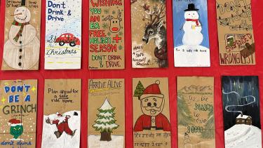 Think of Me Campaign 2023 Paper bags laying flat on a red background. Bags have Christmas themed drawings on them.