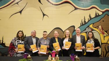 Indigenous Enhancement Agreement Signing 2024 Group of Leaders from local First Nations, Metis community and district representatives, hold up their signed copies of the new enhancement agreement