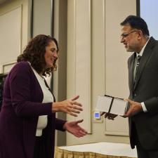 Trustee Rai gifting a long term service box to female employee