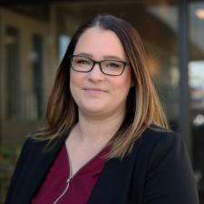 Chelsea Lawley, Human Resources Advisor Woman with brown hair wearing red top and black blazer poses for photo