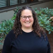Woman wearing glasses smiles