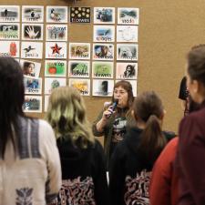 Group of students and staff gathered to learn how to make a drum