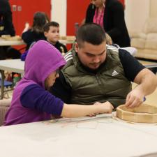 ISW and student working together to make a drum