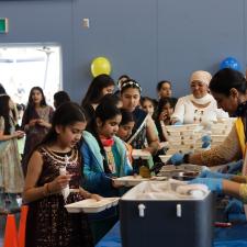 Students in line, receiving their food from the PAC